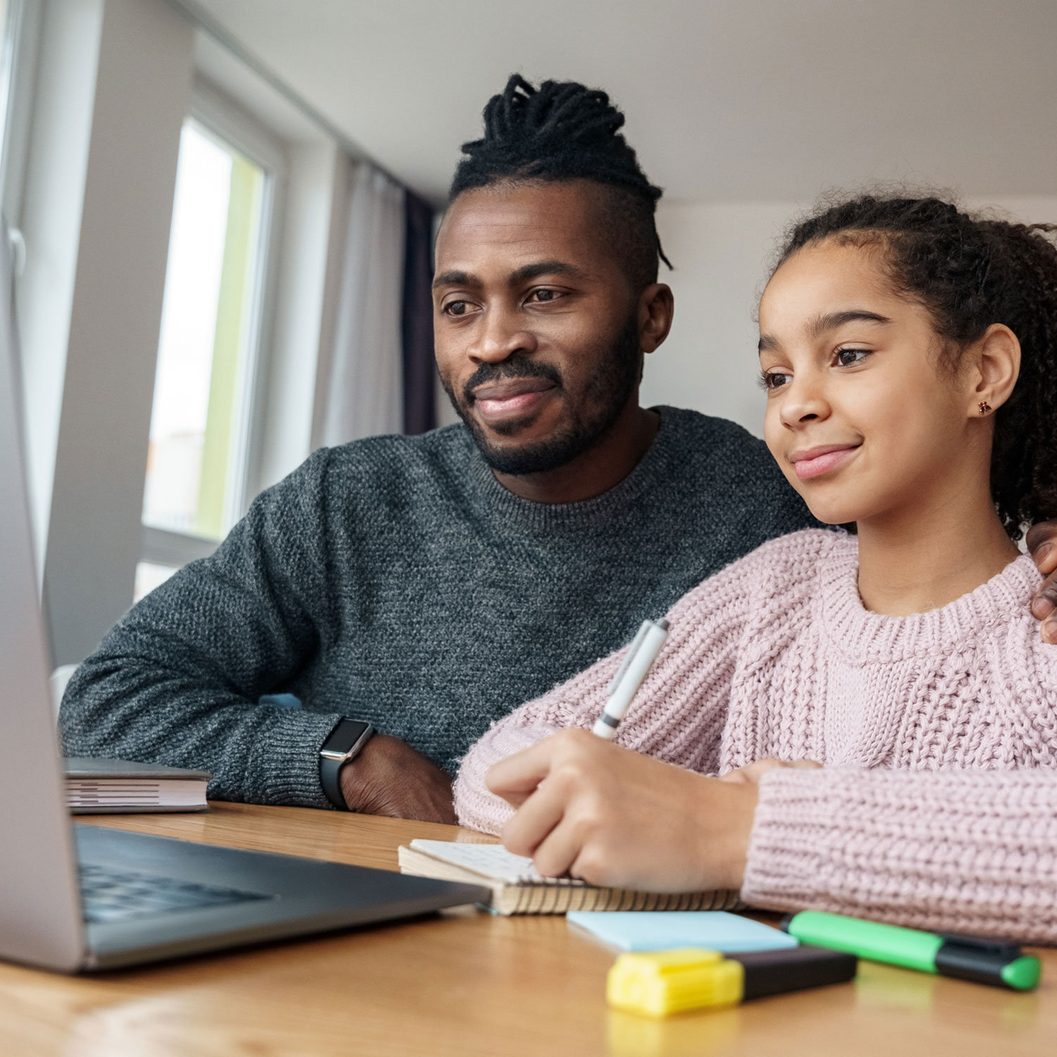 Father and daughter doing online education