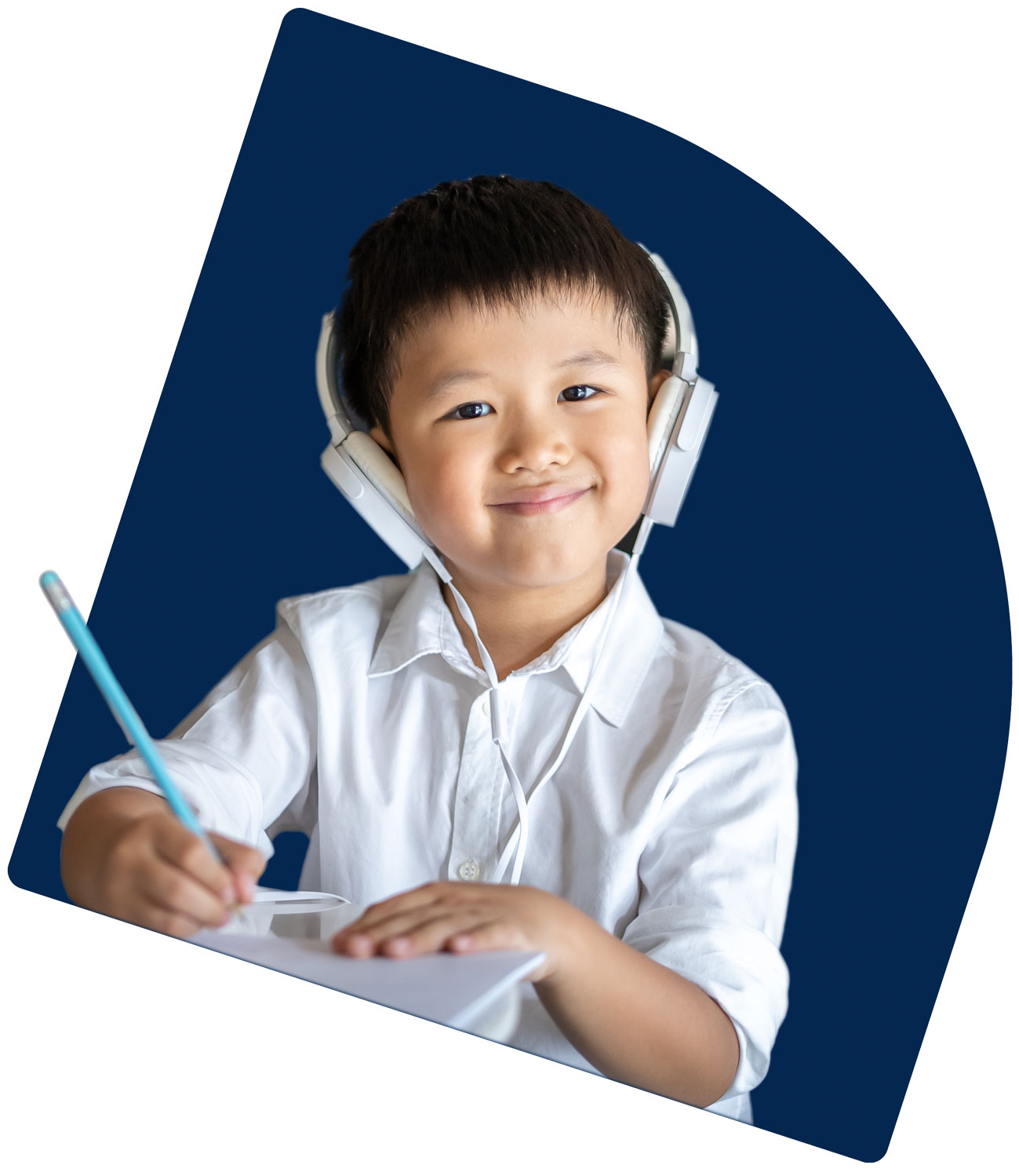 Young student with headphones on writing.