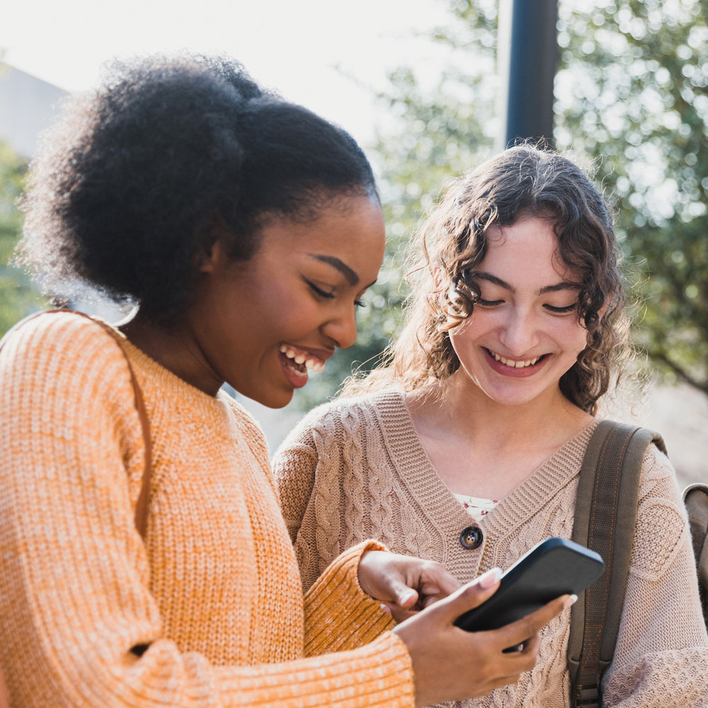 Two students look at Gravitas course listings
