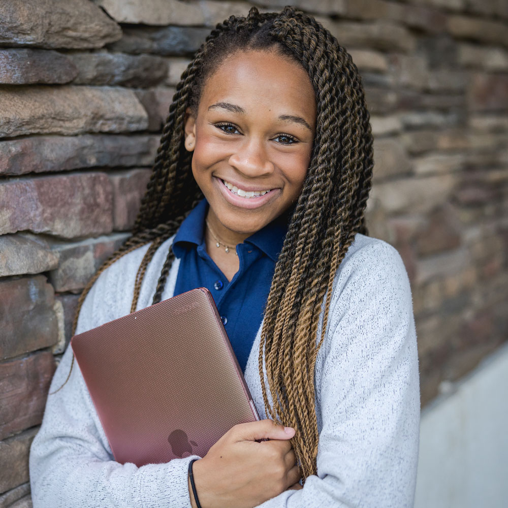 Girl holds laptop